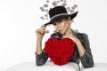 Valentine Beauty girl with red heart roses. Portrait of a young female model with gift and hat, isolated on background. Royalty Free Stock Photo