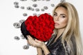 Valentine Beauty girl with red heart roses. Portrait of a young female model with gift, isolated on background. Royalty Free Stock Photo