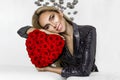 Valentine Beauty girl with red heart roses. Portrait of a young female model with gift, isolated on background. Royalty Free Stock Photo