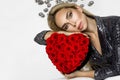 Valentine Beauty girl with red heart roses. Portrait of a young female model with gift, isolated on background. Royalty Free Stock Photo
