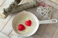 Valentine breakfast. Love funny food on the pan. Two red hearts with scrambled eggs Conceptual love card, flat lay image