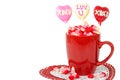 Valentine candy in red mug on doily