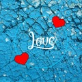 Valentine card with red hearts on cracked blue background