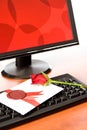 Valentine card with rose on keyboard