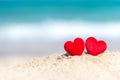 Valentine Concept. Two red hearts on the sand summer beach, Royalty Free Stock Photo