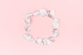 Valentine day background - blank wreath of silver eucalyptus leaves on pastel pink backdrop, top view, copy space.