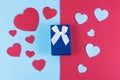 Valentine day background with blue gift box and hearts on devided colored background. Royalty Free Stock Photo