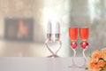 Valentine Day background. A bright table top with two glasses in shape of red hearts with champagner and a bouquet flowers in Royalty Free Stock Photo