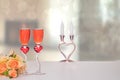 Valentine Day background. A bright table top with two glasses in shape of red hearts with champagner and a bouquet in front of Royalty Free Stock Photo