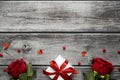 Valentine day background with roses, heart and gift box on wooden table with copy space. View from above Royalty Free Stock Photo