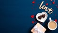 Valentine day banner. Flat lay gift box, coffee cup, heart shaped candy, wooden text sign Royalty Free Stock Photo