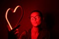 Valentine day. Beautiful girl with neon signs. Neon sign red heart Royalty Free Stock Photo