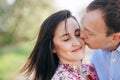 Valentine day. Beautiful young couple sensual hugging and kissing on road in sunshine among spring field and trees. Happy family Royalty Free Stock Photo