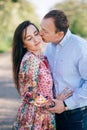 Valentine day. Beautiful young couple sensual hugging and kissing on road in sunshine among spring field and trees. Happy family Royalty Free Stock Photo