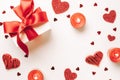 Valentine day composition: red love hearts, romantic gift box, candle on white background. February romance present card. Top View Royalty Free Stock Photo