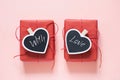 Valentine day composition: two red gift boxes with clothespin as heart with text on chalkboard on pastel pink background. View fro Royalty Free Stock Photo