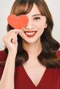 Valentine day concept. Beautiful asian girl holding red heart cover her eyes Royalty Free Stock Photo