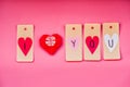 Valentine day holiday. lovely hand made decorations for a valentine day on pink background. i love you labels and origami heart Royalty Free Stock Photo