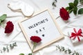 Valentine day concept frame on the white blanket. Holiday top view card with red roses. Royalty Free Stock Photo