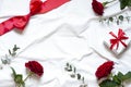 Valentine day concept frame on the white blanket . Holiday top view card with red roses. Royalty Free Stock Photo