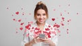 Love message for Valentine day - hearts flying out smartphone in girls hands