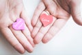 Valentine day concept. Red decorative heart with love inscription and purple heart with inscription forever yours in female hands.