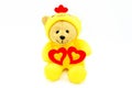 Valentine day concept. Teddy bear doll in yellow chicken dress holding two red hearts isolate on white background. Royalty Free Stock Photo