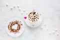 Valentine day decoration, breakfast, white vintage cup and plate, coffee with small marshmallows and hearts made from red paper