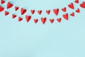 Valentine day greeting card or banner. Paper red hearts garland on blue background