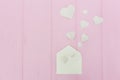 Valentine Day greeting card envelope with hearts. White hearts pours out of the envelope on pink wooden background. Copy Royalty Free Stock Photo