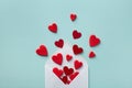 Valentine day greeting concept. Envelope and red hearts on blue background top view. Flat lay Royalty Free Stock Photo