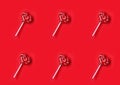 Valentine day, heap striped lollipops shape heart on stick, on red paper background