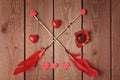 Valentine' day heart shape chocolate and arrows on wooden background