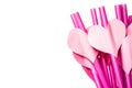 Valentine day holiday. bright pink drinking straws with hearts and a pink ribbon in a glass isolated on white Royalty Free Stock Photo