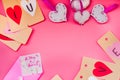 Valentine day holiday. hand made decorations for a valentine day on pink background. i love you labels, hearts and origami enve Royalty Free Stock Photo