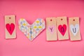 Valentine day holiday. lovely hand made decorations for a valentine day on pink background. i love you labels and origami heart Royalty Free Stock Photo