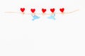 Valentine day layout. Red heart and doves love on wooden clothespins on jute twine on white background. St. Valentines Day, day Royalty Free Stock Photo