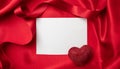 Valentine red color ruby heart on empty card on red silk fabric background Royalty Free Stock Photo