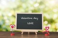 Valentine day and LOVE text on black board and wood table top wi Royalty Free Stock Photo