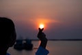 Valentine day and Marry Concept. Female model is showing mini heart hand symbol on the beach sunset or sunrise background