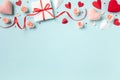 Valentine day or mother day composition with gift or present box, rose flowers and red pink hearts on pastel blue background Royalty Free Stock Photo