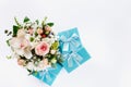 Valentine Day or Mother Day concept. Flower bouquet with gift on white background. Flat lay top view floral composition