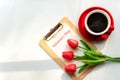 Valentine day. Red Lilly with red cup coffee on white background. Royalty Free Stock Photo