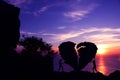 Valentine day, Silhouette couples are pushing the broken heart-shaped stone. Royalty Free Stock Photo