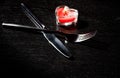 Valentine day table setting with knife, fork, red burning heart shaped candle Royalty Free Stock Photo