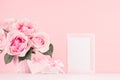 Valentine days background - elegant pastel pink roses bouquet, decorative frame for text, heart with ribbon, gift box on white. Royalty Free Stock Photo
