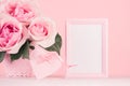 Valentine days background - elegant pastel pink roses bouquet, decorative heart with ribbon, blank frame for advertising on white. Royalty Free Stock Photo