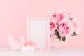 Valentine days decor for home in soft pastel pink - romance bouquet of roses, heart, gift box with perls, ribbon and blank frame.