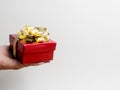 Valentine festival , New year Gold gift box with red ribbon. Red background for create idea copy space.