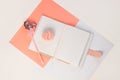Valentine flatlay. Blank diary, pink heartshaped pen feathers on white background. Notebook mockup, cute girlish style
